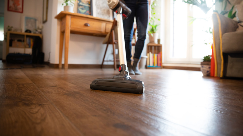 Person vacuuming floor