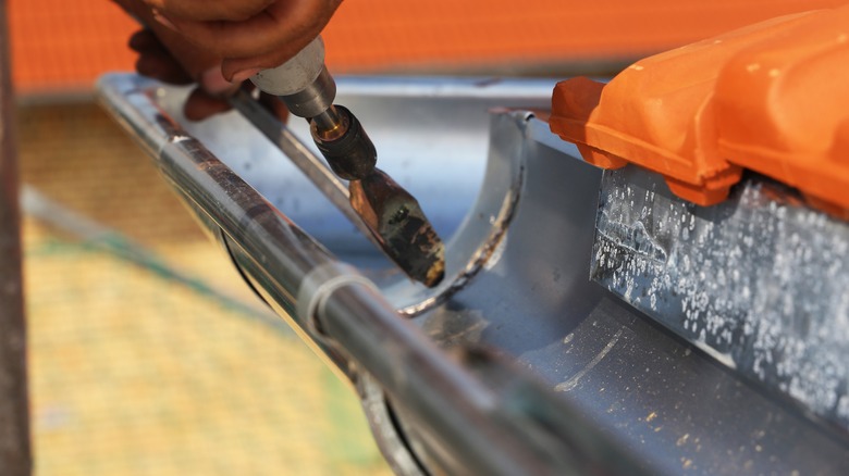 man working on gutter