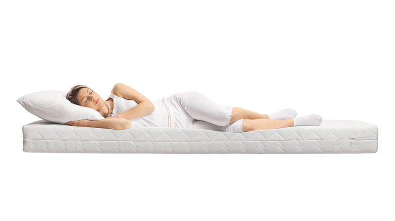 woman sleeping on a mattress