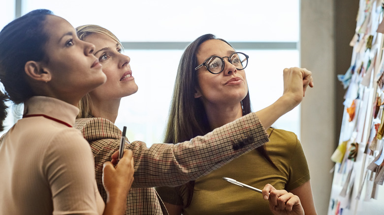 Women looking at board project