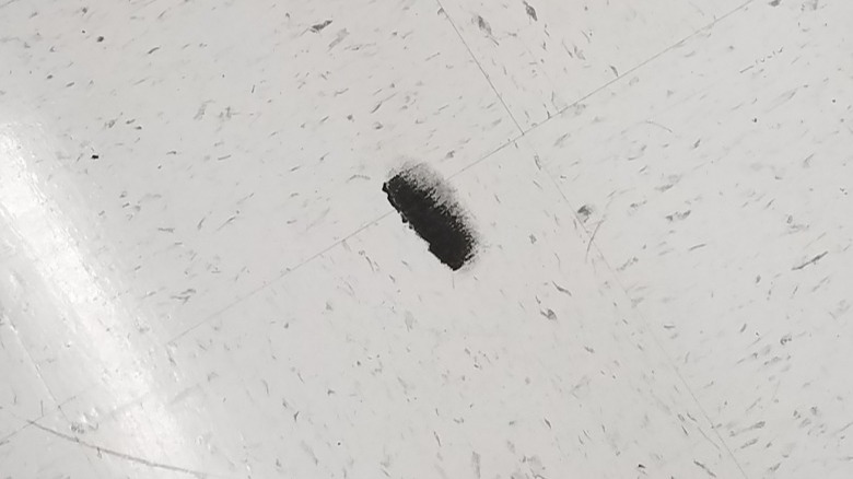 black scuff mark on white floor