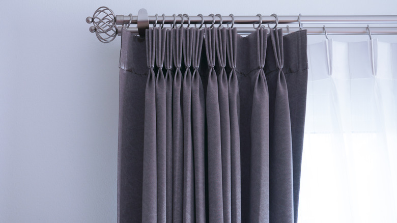 Dark curtains pinch-pleated