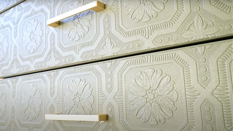 Dresser with textured wallpaper