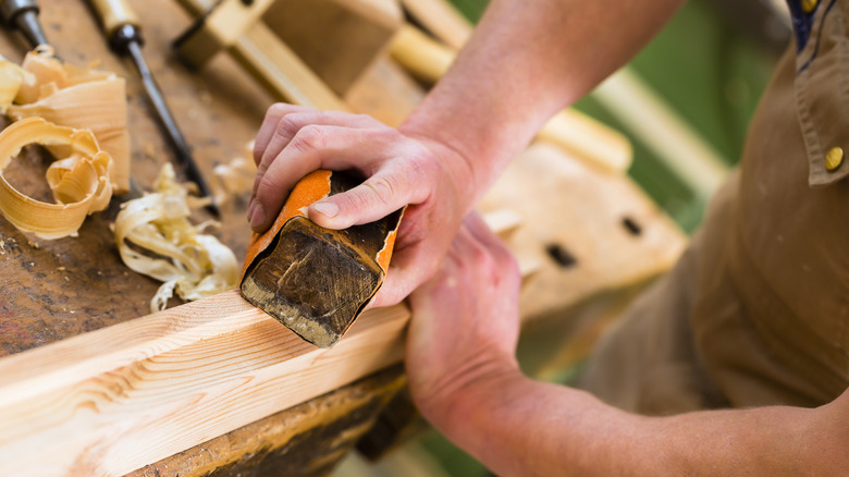 Man sanding wood 