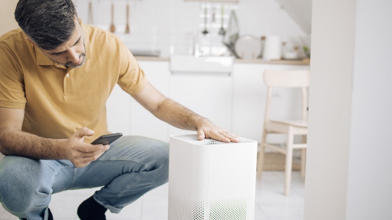 Man setting up air purifier