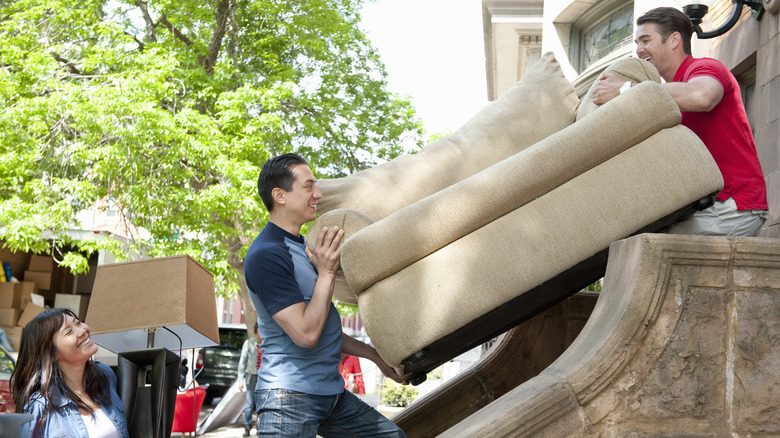 two men moving a couch