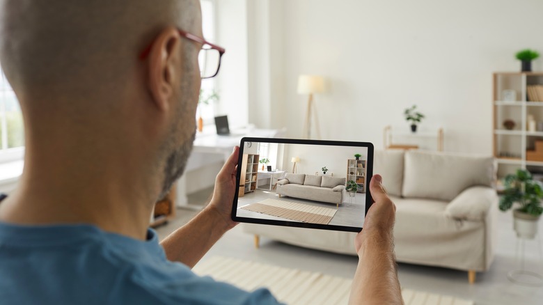 man taking photo of couch