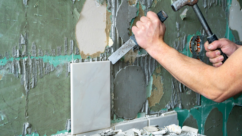 person removing tiles 