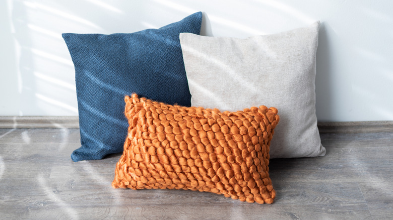 Throw pillows of various textures and colors