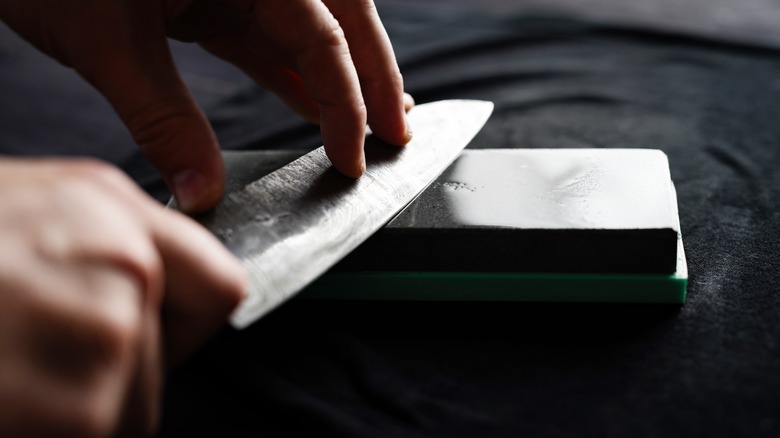 man sharpening a knife