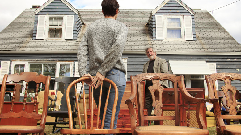 A person buying an old chair at a tag sale