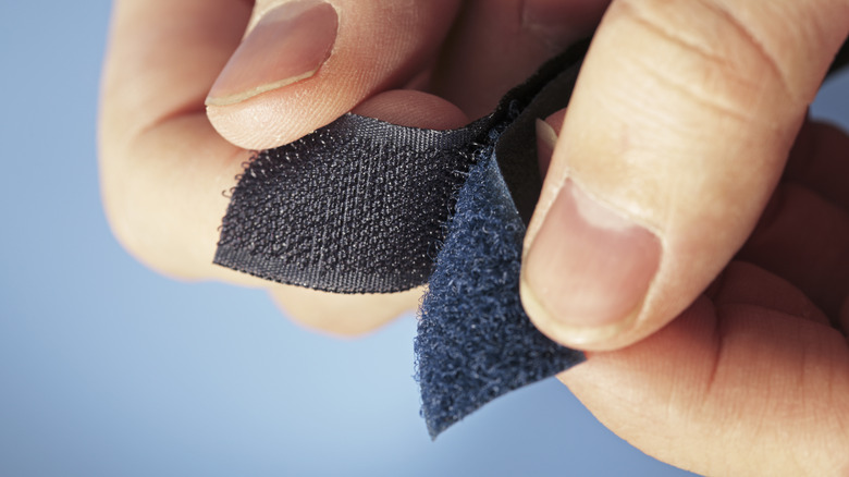 person holding velcro strips