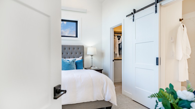 bedroom with barn door for bathroom