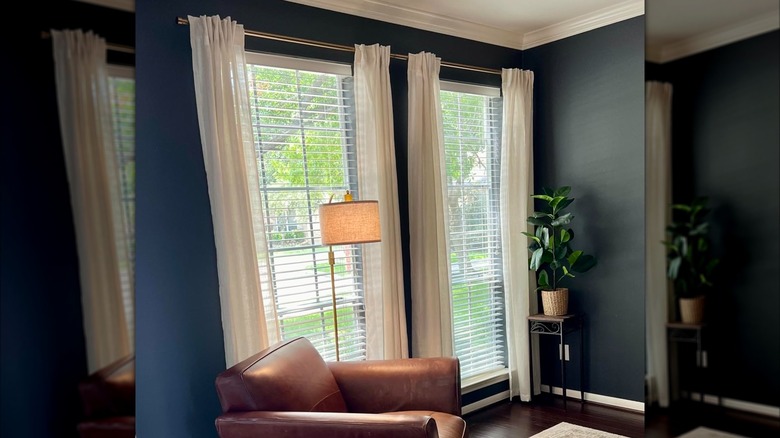 Gold curtain rod installed in blue sitting room