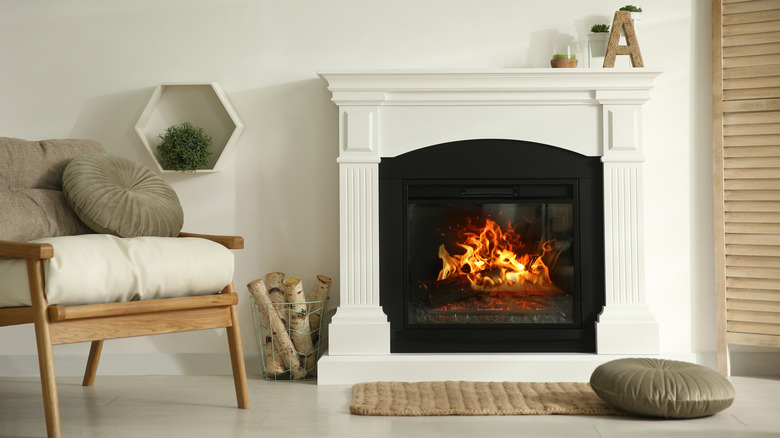 lit fireplace with white mantel