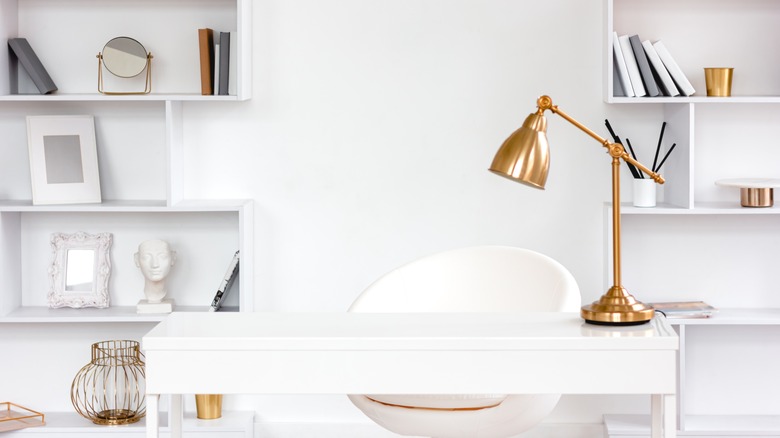 gold desk lamp on table