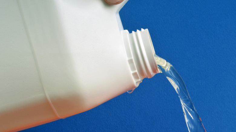 bottle of bleach being poured