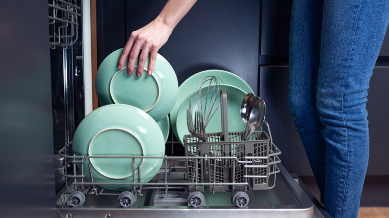 Putting dishes in dishwasher