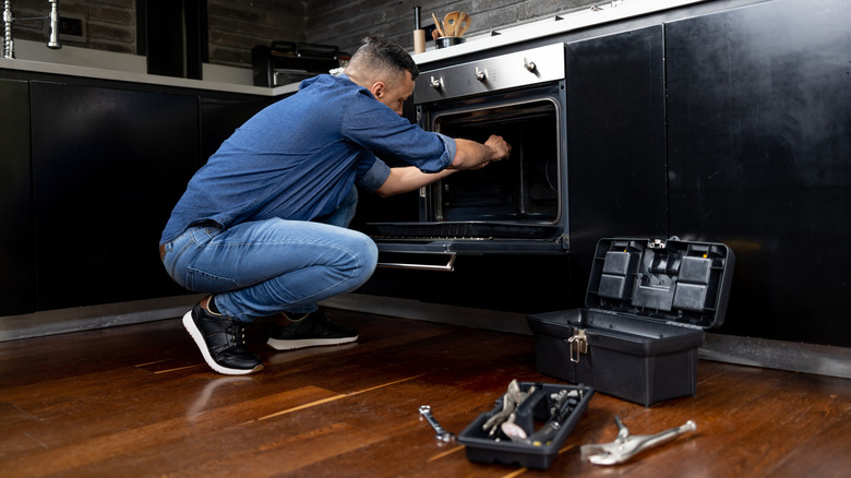 Man repairing oven