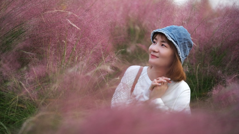 woman in muhly grass garden