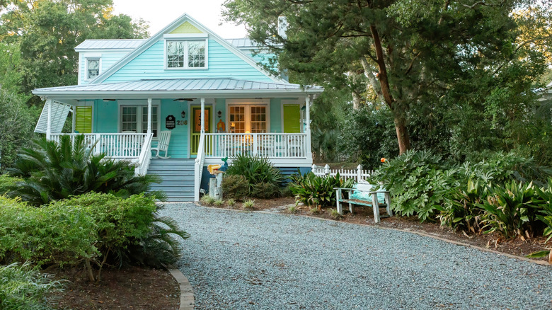 A house with a gravel driveway on a slight slope