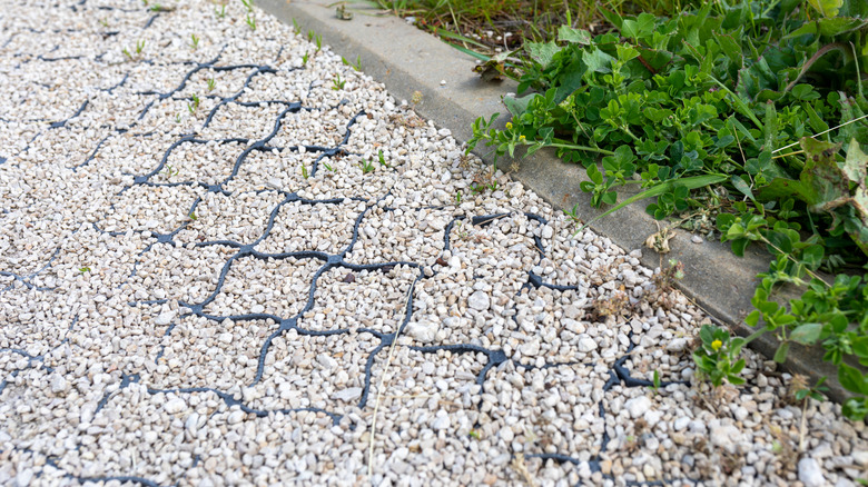 A garvel grid system used to retain gravel in a well-used pathway