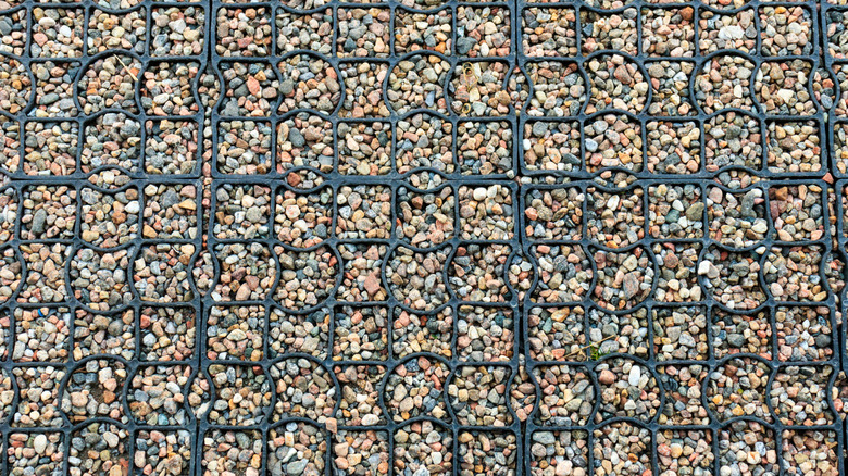 A section of driveway showing a gravel grid filled with pea gravel