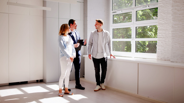 Couple meeting with an interior designer and looking at window