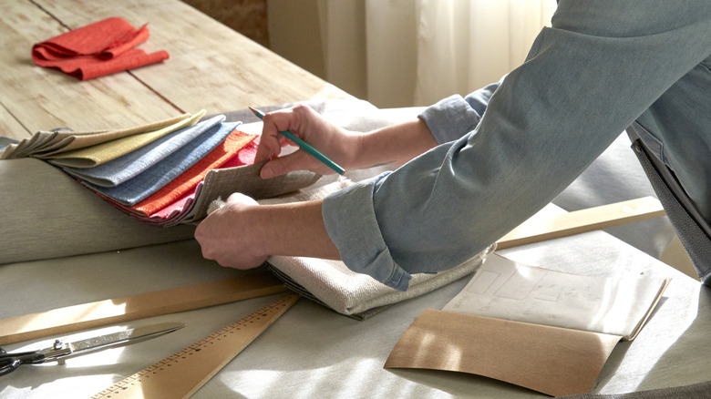 Interior designer looking at fabric swatches for curtains