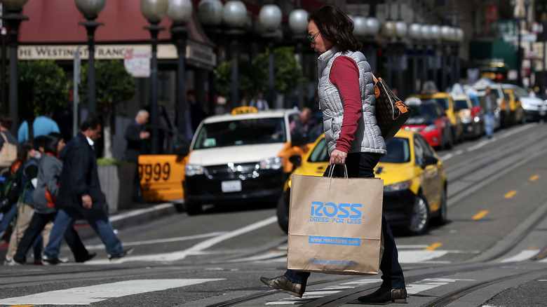 Pedestrian with large Ross paper shopping bag