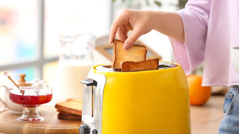 pulling toast out of toaster