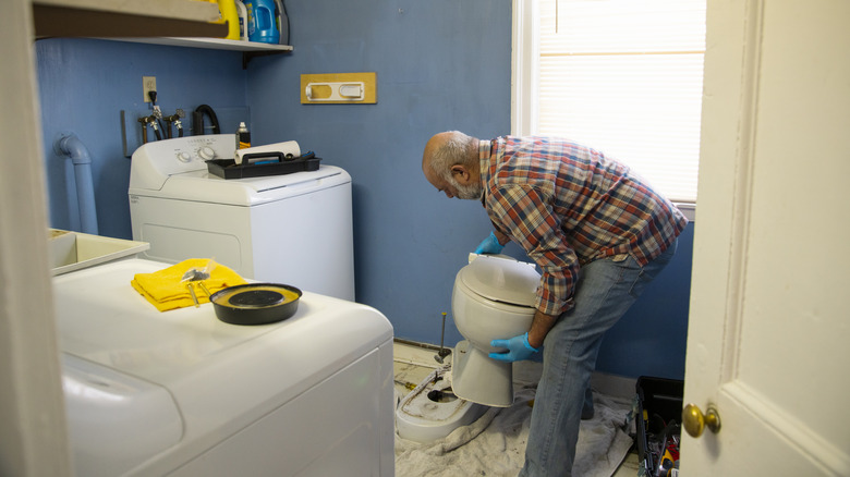 Man moving a toilet