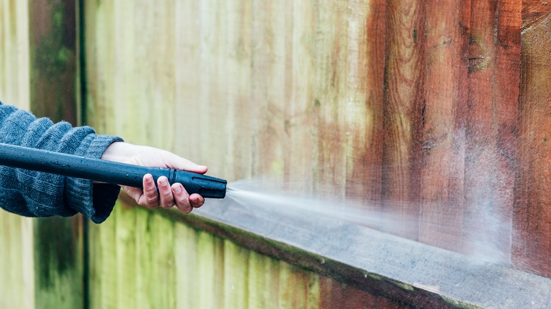 Pressure washing wooden wall