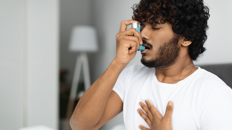 Person using an inhaler