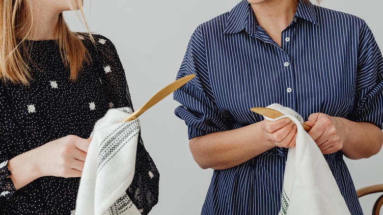 People drying wooden spoons 