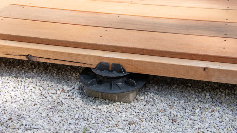 Crushed stone gravel underneath wood deck