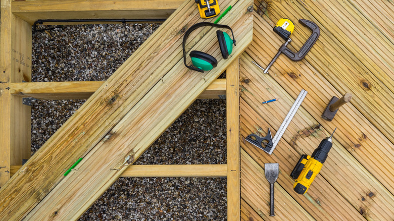 Deck construction in progress with gravel beneath