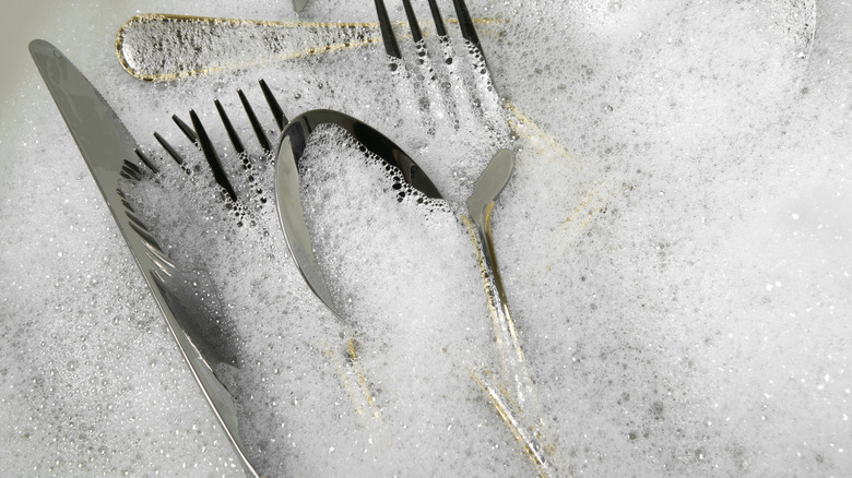 Silverware in suds