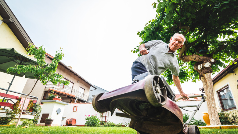 Man trying to start mower