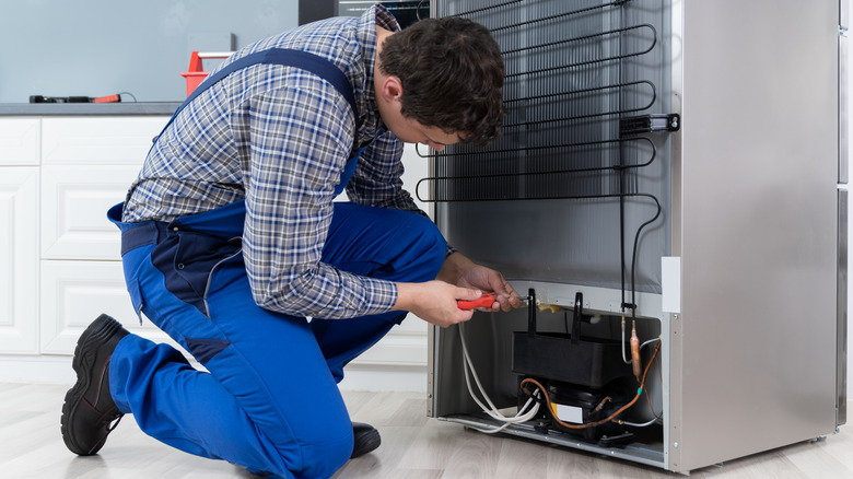 Person repairing refrigerator