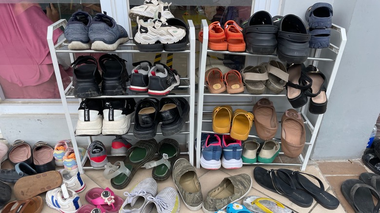 Messy shoe racks surrounded by shoes