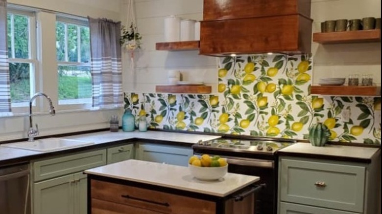 Kitchen with lemon wallpaper above stove and countertops