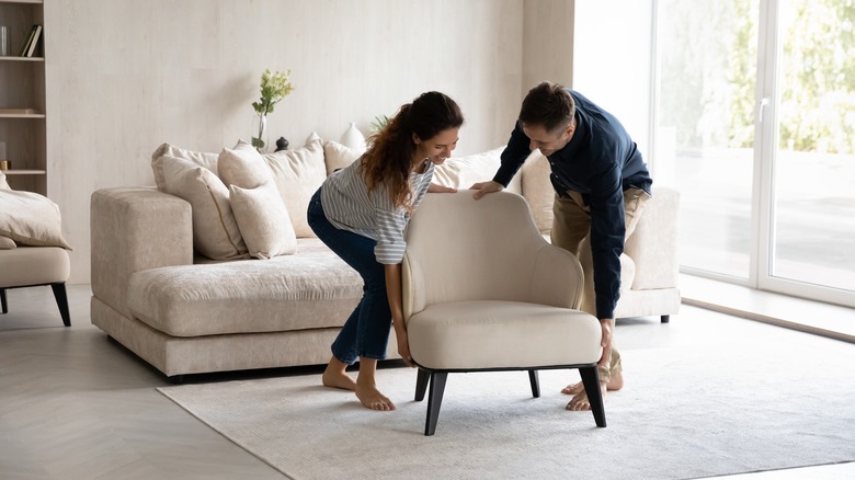 Couple moving armchair