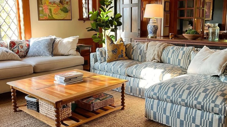 Erin Napier's living room with a handed down, reupholstered cream sofa and a blue and white sectional