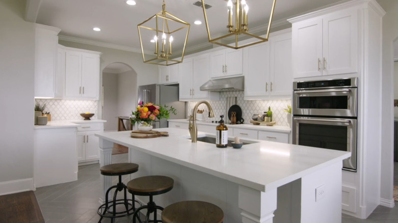 A white kitchen with a large island