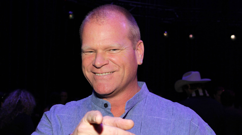 Mike Holmes smiling and pointing at the camera