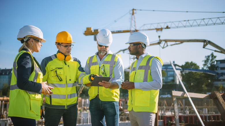 four people at construction site