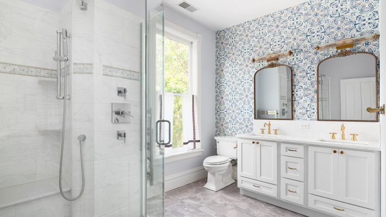 Bathroom with wallpaper behind sink