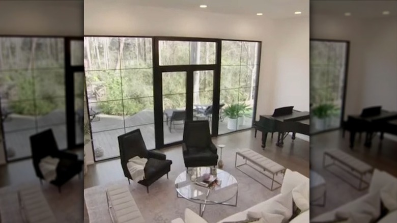 Black and white living room from Love It or List It episode with large glass doors and window unit