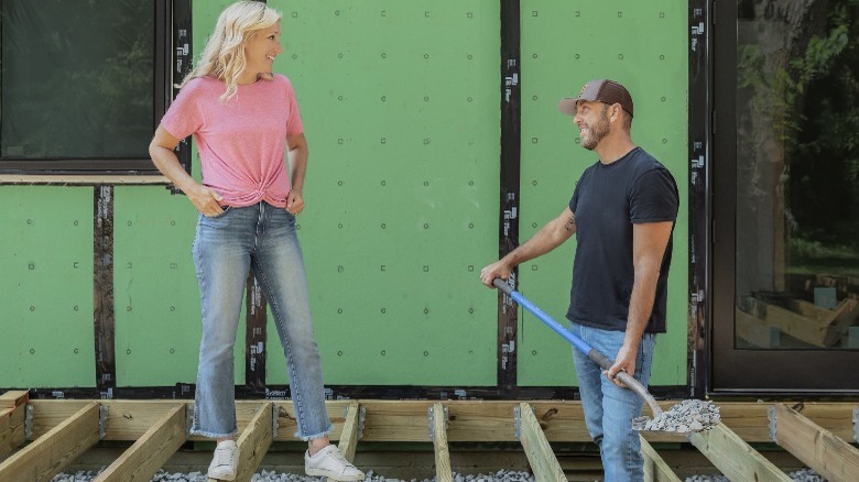 Jenny and Dave Marrs standing on wood beams